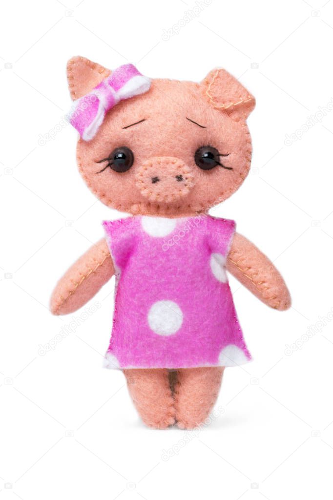 Little toy pig in a dress on a white isolated background