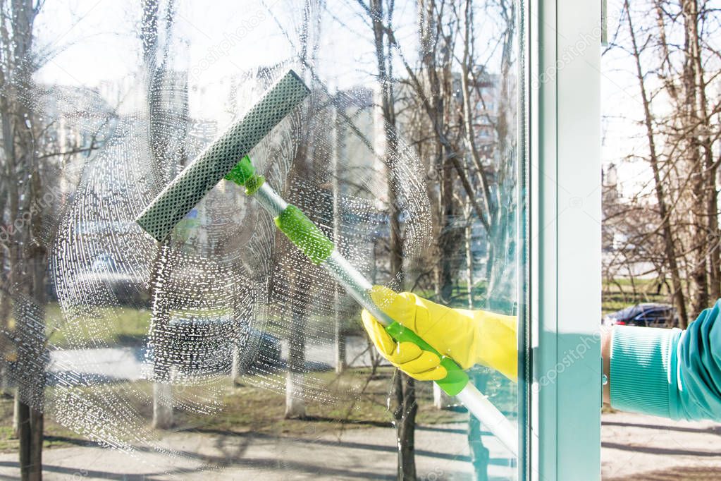 scraper cleans the window