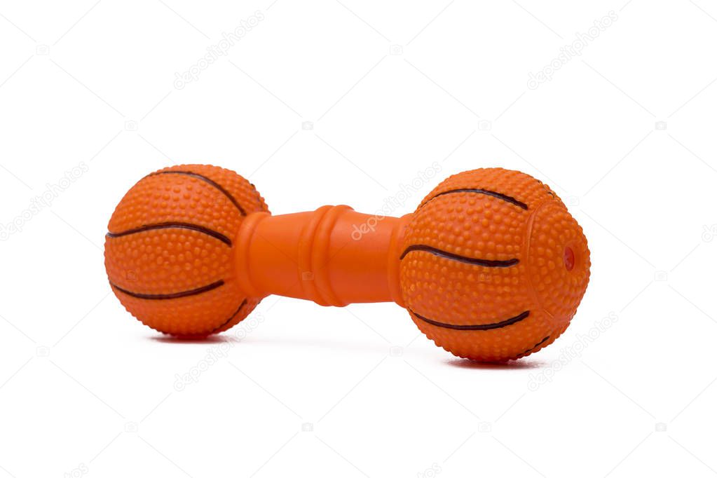 Dog toy in the form of an orange dumbbell on an isolated background