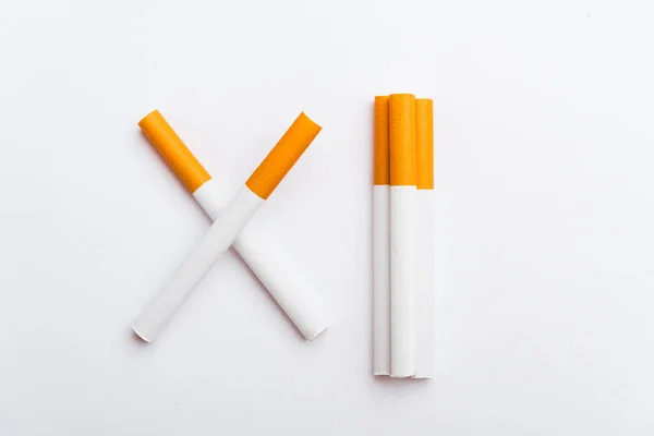 31 May of World No Tobacco Day, no smoking sign two cigarettes crossed slashes close up full pile cigarette or tobacco on white background with copy space, and Warning lung health concept