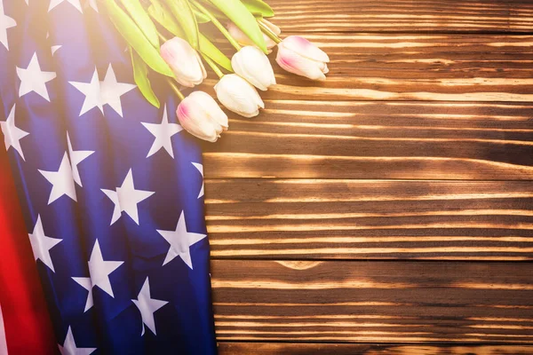 Happy Memorial Day Remember previously but now seldom called Decoration Day, American USA flag and a Tulip flower on wooden background and copy space, a federal holiday in the United States