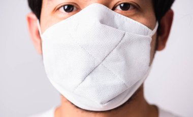 Coronavirus 'a karşı cerrahi hijyenik koruyucu yüz maskesi takan Asyalı yakışıklı adam, izole edilmiş beyaz arka plan, COVID-19 tıbbi konsept.