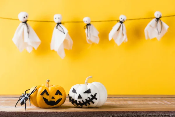 stock image Funny Halloween day decoration party, Baby cute white ghost crafts scary face hanging and halloween pumpkin head jack lantern smile and spider on wooden, studio shot isolated, Happy holiday concept