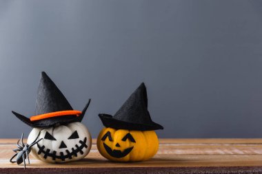 Komik Cadılar Bayramı dekorasyon partisi, Cadılar Bayramı balkabağı kafası yakın plan Jack o fener gülüşü korkutucu ve örümcekler ahşap ve fotokopi alanı, izole edilmiş gri arka plan, Mutlu bayramlar konsepti