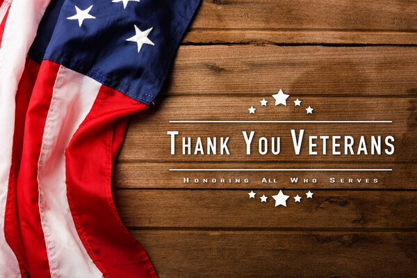 Top view overhead America United States flag, memorial remembrance and thank you of hero, studio shot with copy space on wooden table background, USA holiday Veterans or Independence day concept