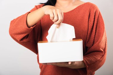 Young woman flu she using hand taking pulling white facial tissue out of from a white box for clean handkerchief, studio shot isolated on white background, Healthcare medicine concept clipart