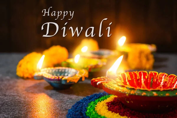 关闭的粘土点燃了已经在Diya或油灯上燃起的篝火 在混凝土背景上放了花 装饰了印度教 Hinduism Rangoli 愉快地庆祝了Deepavali 或Diwali印第安人节日的概念 — 图库照片