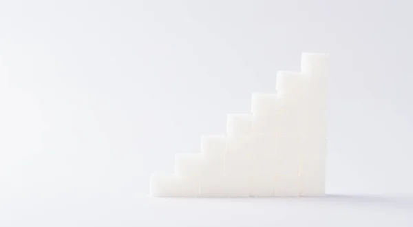 Ascending stacks of sugar cubes graph chart, studio shot isolated on white background, health high blood risk of diabetes concept