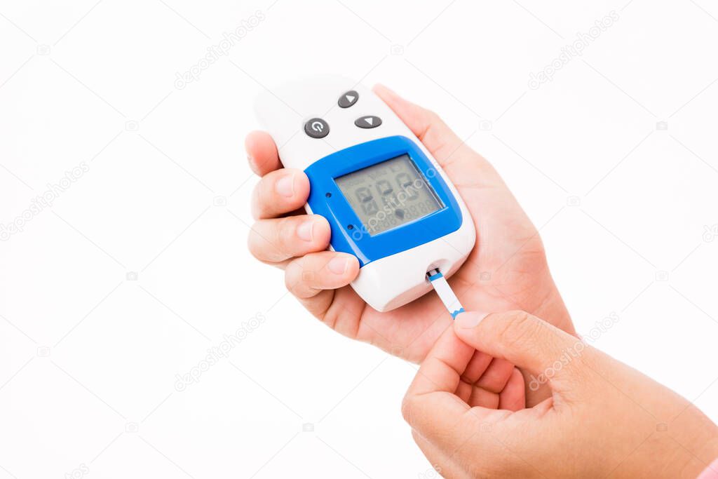 Closeup hands woman measuring glucose test level checking on a finger by glucometer she monitors and controls high blood sugar diabetes and glycemic health care concept isolated on white background