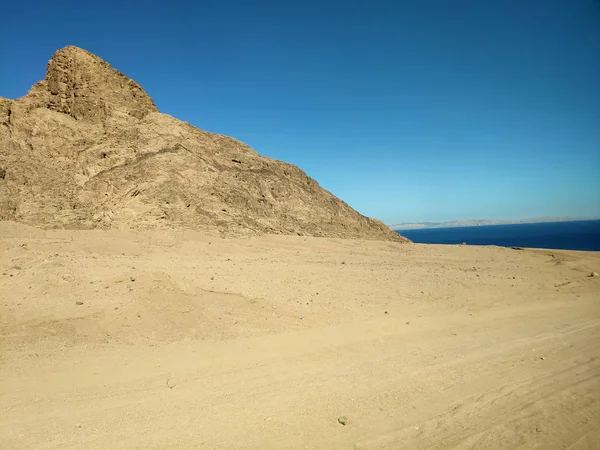 Woestijn land met bergen en zee — Stockfoto