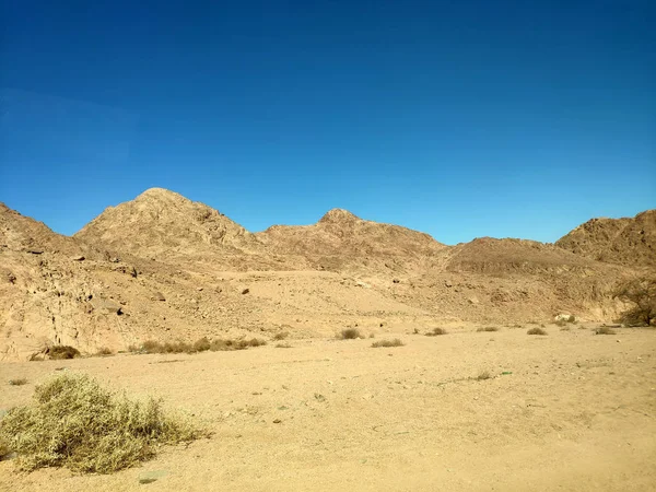 Desert land with mountains and sea