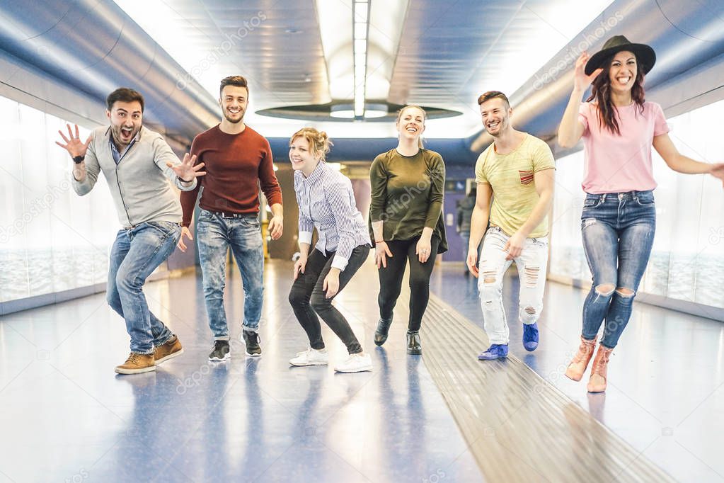 Group of friends having fun together in underground station - Young people getting ready for party - Happiness, nightlife, friendship and youth lifestyle concept
