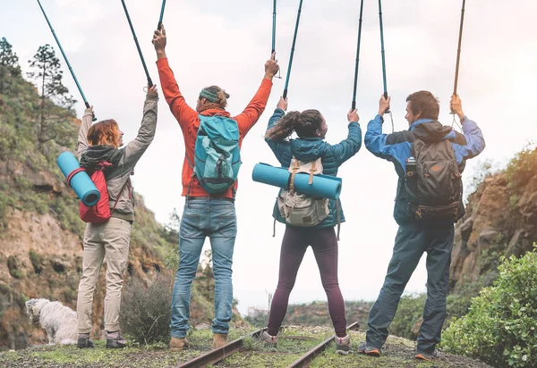 Group Friends Raising Hands Holding Trekking Poles Peak Mountain Young — Stock Photo, Image