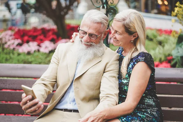 Boldog vezető pár figyeli a mobil okostelefon kültéri-érett divat nyugdíjasok szórakozik az új technológia cellphones apps-szociális, nyugdíjas, Tech, idős életmód koncepció — Stock Fotó