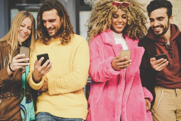 Group of friends watching on their mobile phones outdoor - Millennial young people having fun with new technology smartphone trends - Generation z, social media, tech and youth lifestyle concept — Stock Photo, Image