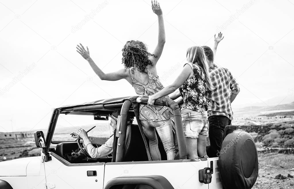 Group of friends driving off road convertible car during roadtrip - Happy travel people having fun in vacation - Friendship, transportation and youth lifestyle holidays concept