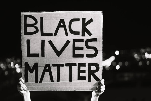 Black lives matter banner - Activist movement protesting against racism and fighting for equality - Social protests and human rights concept - Black and white editing