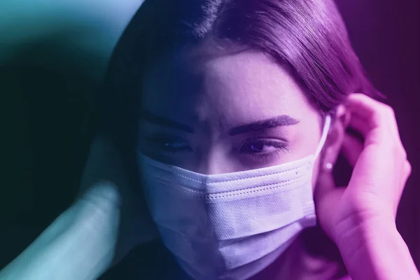 Young woman wearing face surgical mask against corona virus - Fear girl quarantine for preventing pandemic spread of coronavirus - Mental health impact during covid19 and anxiety people concept