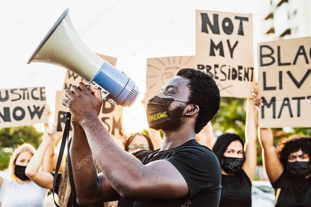 Black lives matter activist movement protesting against racism and fighting for equality - Demonstrators from different cultures and race protest on street for equal rights