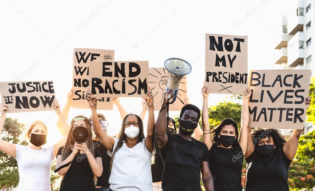 Activist movement protesting against racism and fighting for equality - Demonstrators from different cultures and race protest on street for equal rights - Black lives matter protests city concept