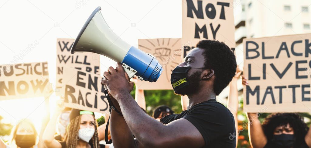 Activist movement protesting against racism and fighting for equality - Demonstrators from different cultures and race protest on street for equal rights - Black lives matter protests city concept