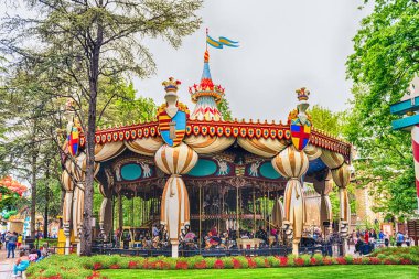 CASTELNUOVO DEL GARDA, ITALY - MAY 1: Old fashioned vintage carousel at Gardaland Amusement Park, near Lake Garda, Italy, May 1, 2018. The park attracts nearly 3 million visitors every year clipart