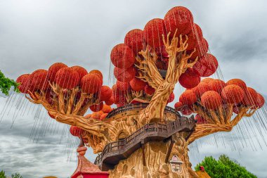 CASTELNUOVO DEL GARDA, ITALY - MAY 1: Giant tree inside Gardaland Amusement Park, near Lake Garda, Italy, May 1, 2018. The park attracts nearly 3 million visitors every year clipart
