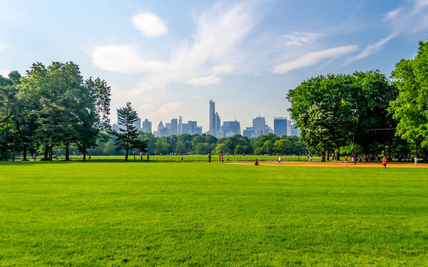 Central Park on a sunny day and a beautiful contrast with skyscrapers and buildings, Manhattan, New York City, USA