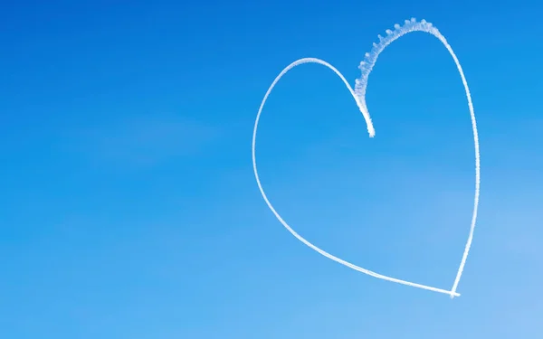 Romantic heart written by an aircraft in the sky, with copy space. Concept for Valentine\'s day