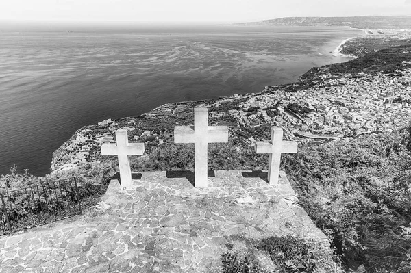 The iconic Three Crosses on the top of Mount Sant\'Elia overlooking the town of Palmi on the Tyrrhenian Sea, Italy