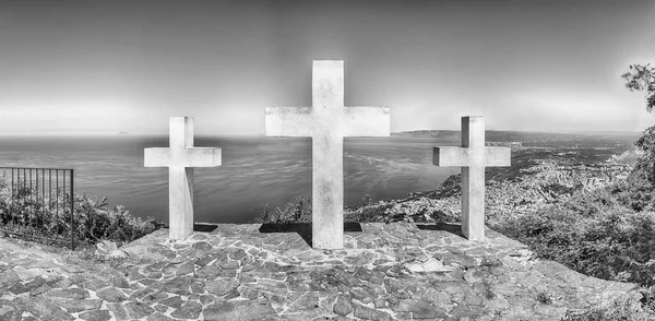 The iconic Three Crosses on the top of Mount Sant'Elia overlooking the town of Palmi on the Tyrrhenian Sea, Italy