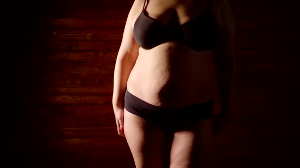 Concept of obesity. close-up of the body of a fat woman in underwear in a dark room — Stock Footage Concept of obesity. close-up of the body of a fat woman in underwear in a dark room Stock Footage