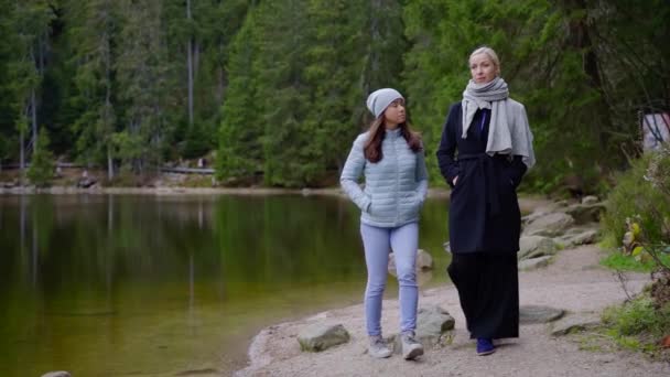 Two Adult Women Walking Shore Calm Forest Lake Autumn Day Video By C Yarmedia Stock Footage