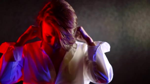 Woman With Short Hair In White Shirt In Neon Light Red And Blue On