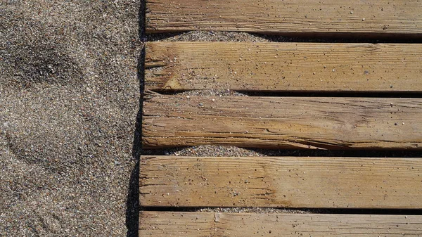 background texture wood wooden layers of old flooring on the sandy beach