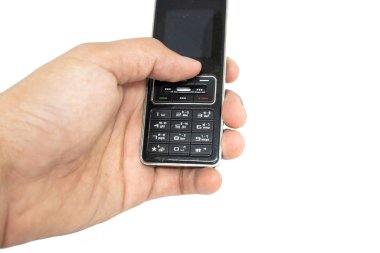 Parmak beyaz izole die kesilmiş arka plan ile cep telefonu eski nesil tutan. 1995-2010 yüzyıl boyunca geleneksel cep telefonu.