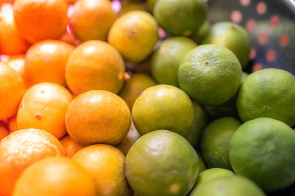 Green lemon lime or Thailand lemons on metal basket with orange light effect. Abstract of sweet, sour flavor and Thirsty.