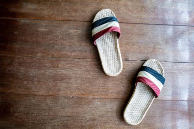 Ahşap zemin yüzeyi arka planda el yapımı tarafından örme örgü. Kırmızı ve mavi renkte Ayakkabı çifti evde eşymaya hazır. Konfor ev kavramı Relax ve tatil boş zaman.