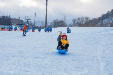 Hokkaido, Japonya - Aralık 2019: Hokkaido Japonya 'nın başkenti Sapporo' daki Dağ Kulübü kayak merkezinde kayak yapan Asyalı kızın fotoğrafı