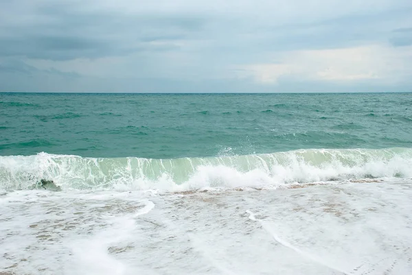 Long wave that breaks on the tropical beach, sea nd sky