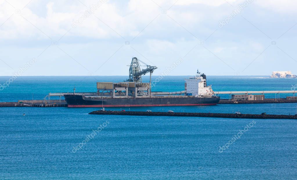 Supply tanker offloading fuel and supplies to harbour at Portland, Victoria, Australia