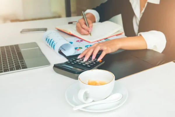 Accounting woman working, Focus on empty cup of coffee, Business and Office Concept.