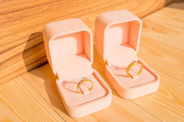 Beautiful wedding rings in box on wooden background