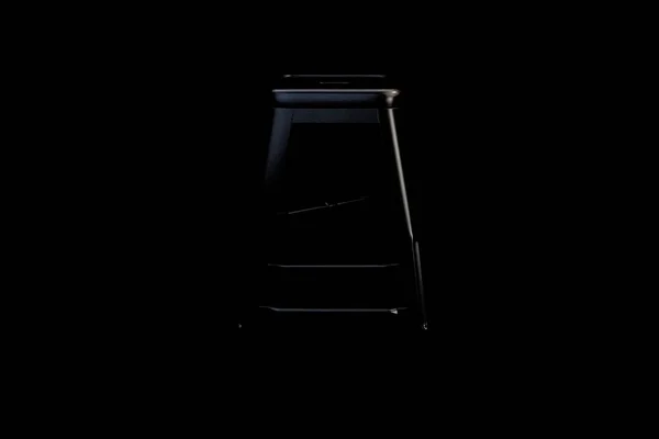 Black metal bar stool with step on black background. Loft chair. 3d render