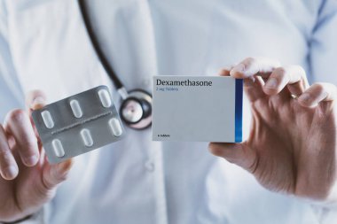 Doctor holding Dexamethasone steroid drug clipart