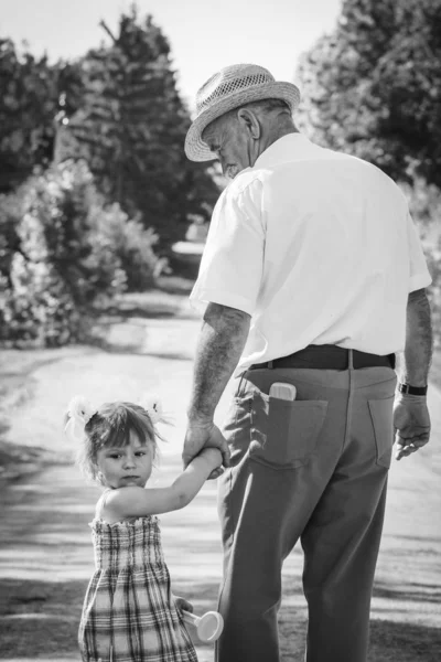 Grandfather with the grandson go on the road — Stock Photo, Image