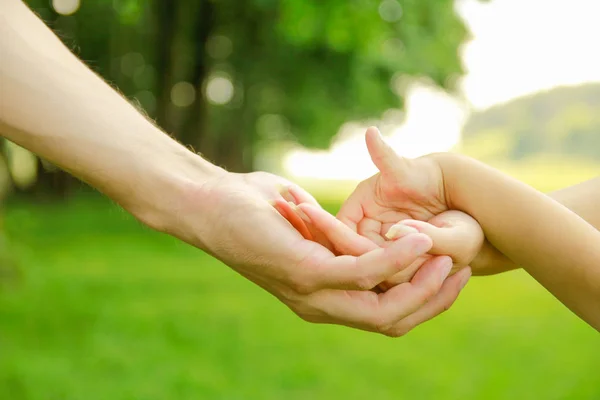 Hands Happy parents and child outdoors in the park — Stock Photo, Image