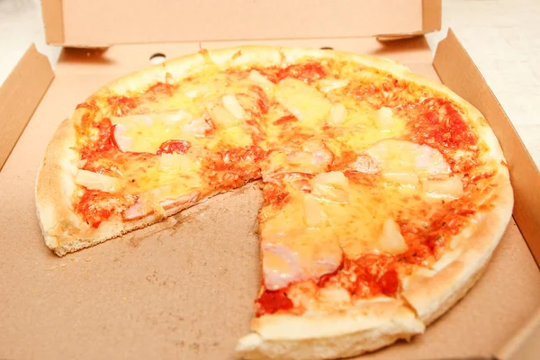 Gorący kawałek pizzy z topiącym się serem na rustykalnym drewnianym stole — Zdjęcie stockowe