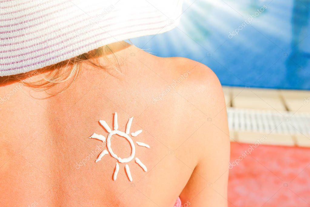 happy girl with the sun on her back at the pool in the nature