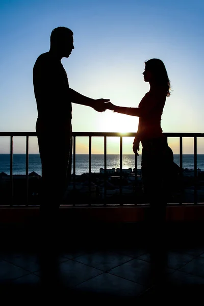 Beautiful couple silhouette on nature near the sea on a rift bac